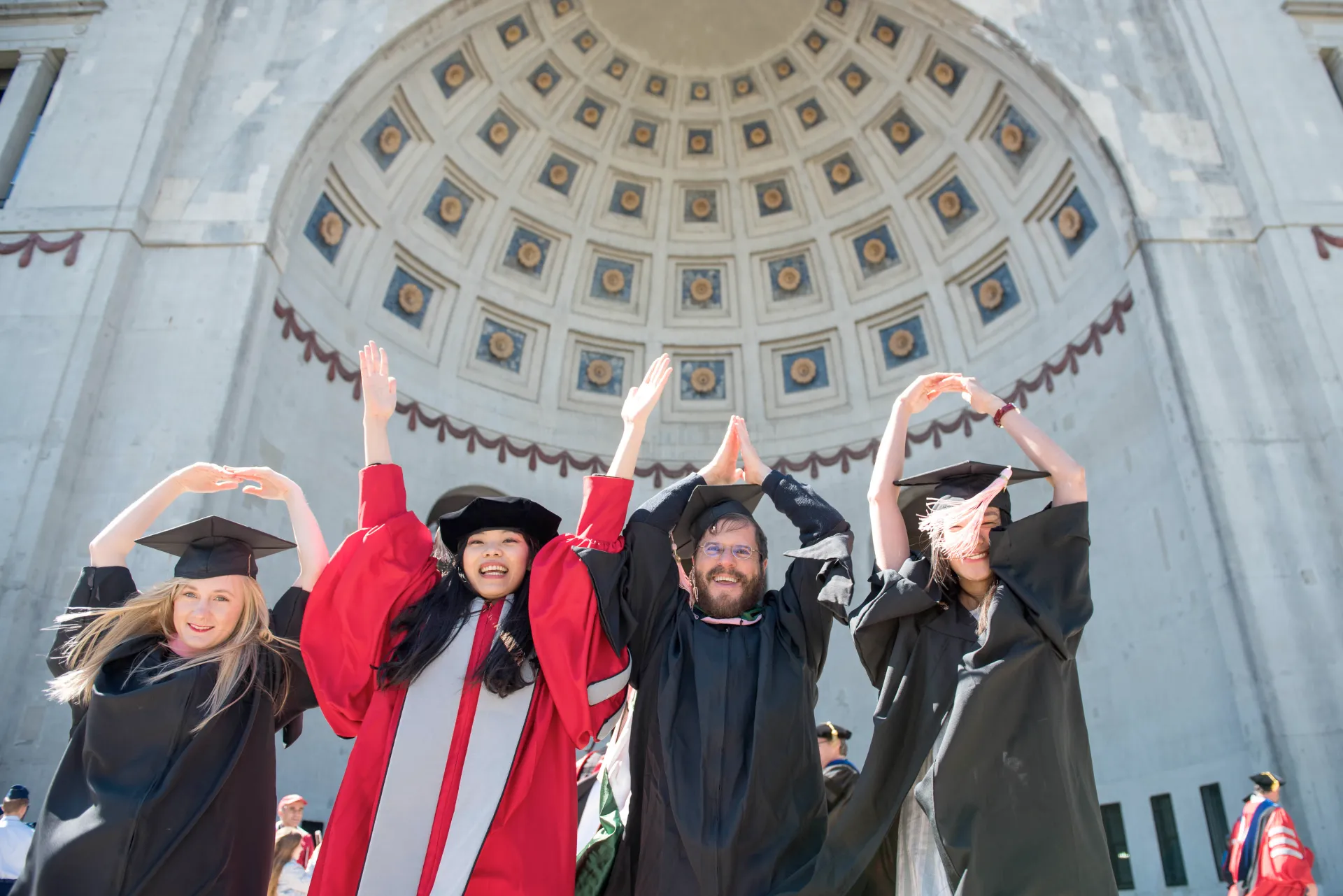 graduates in front of stadium